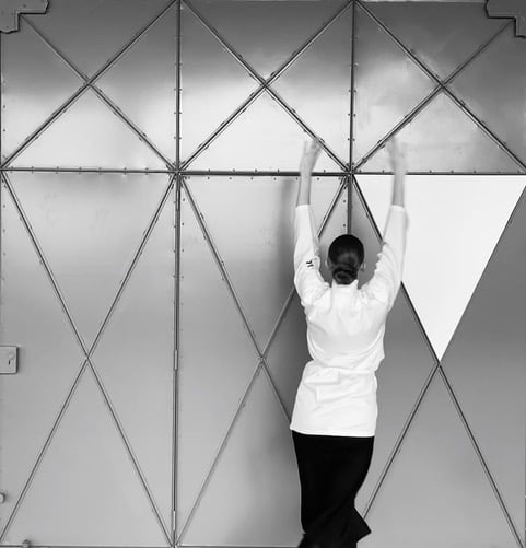 Anderson dancing with one of the replicated elements of Calder’s door, 2019